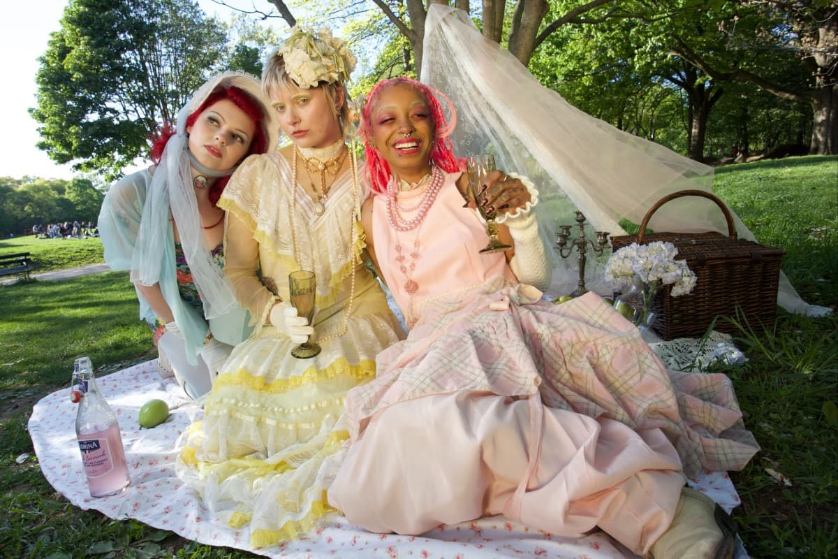 Friends in vintage dresses gathered outdoors